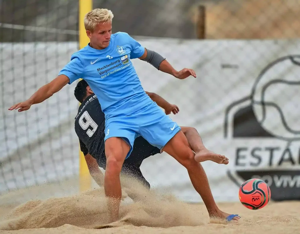 Getting tackled in beach soccer