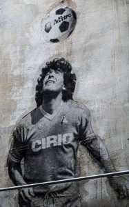diego maradona juggling a ball with his head - street art