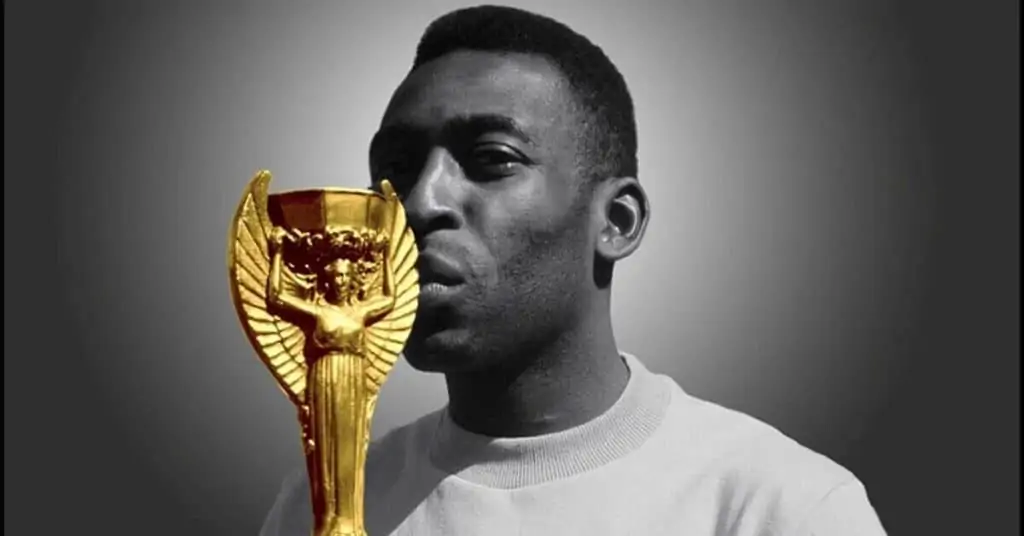 pele kissing the world cup trophy after scoring the most world cup goals