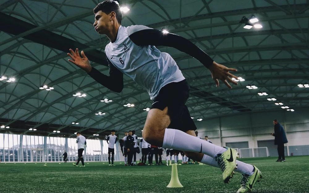 man sprinting on indoor soccer field