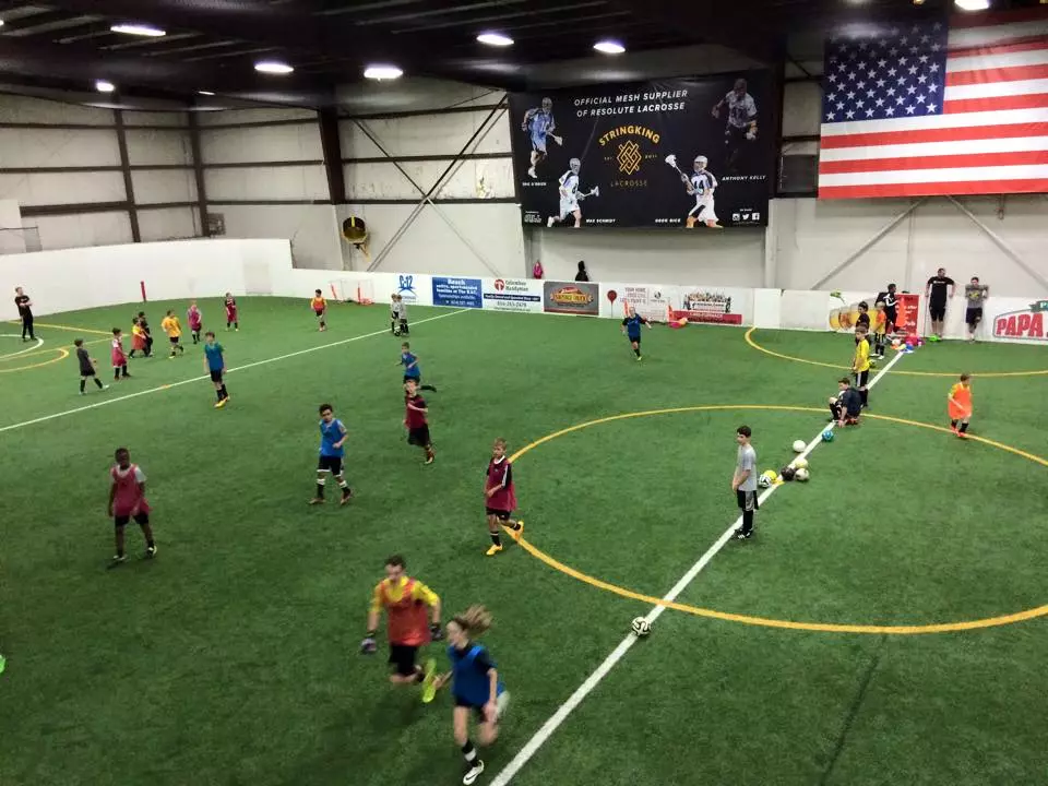 kids playing soccer indoors