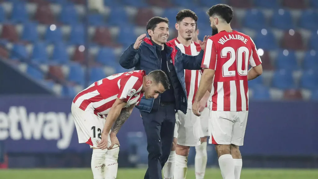 Marcelino Garcia Toral hugging his players after a win