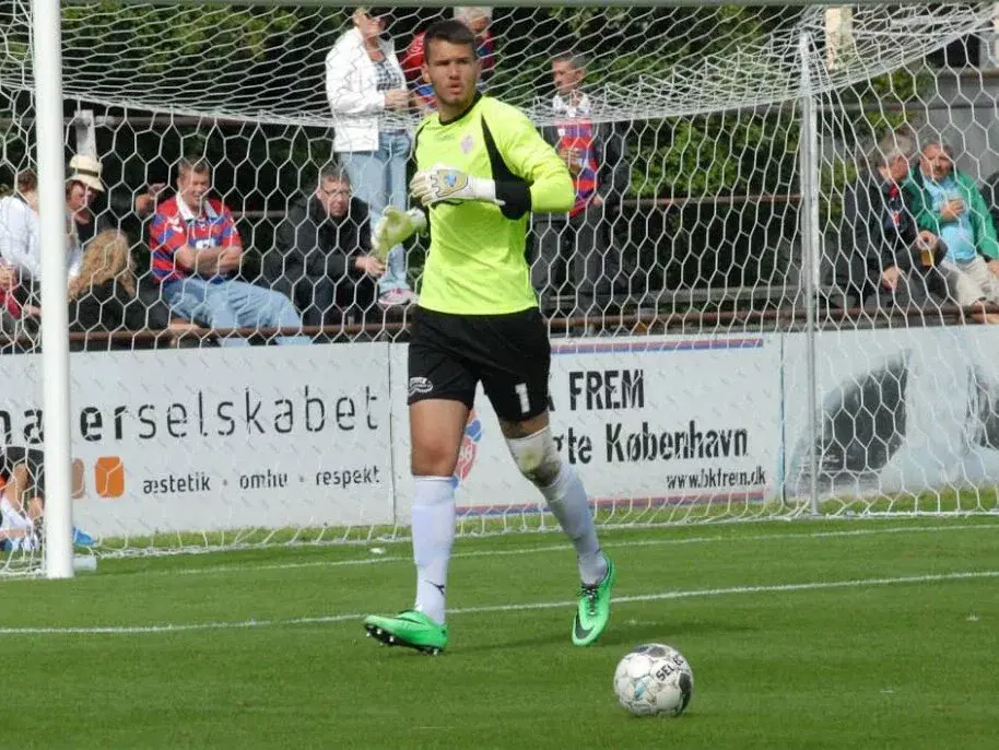 Simon Bloch Jorgensen about to kick the soccer ball up the field