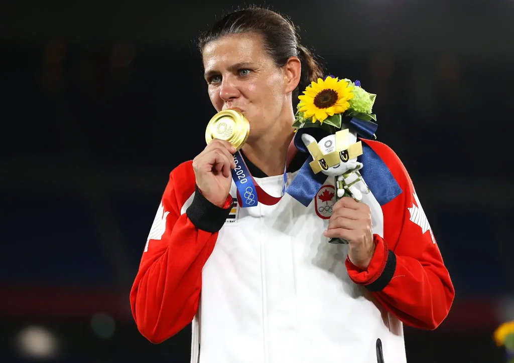 christine sinclair kissing her gold medal after winning the women's soccer at Toyko 2021