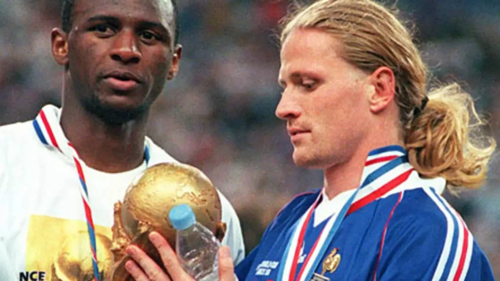 french footballing internatonals Petit and Patrick Vieria with world cup trophy