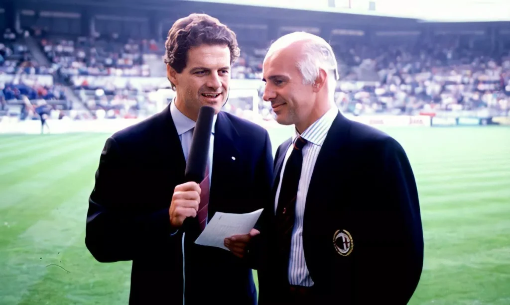 fabio capello and arrigo sacchi together for a interview on the side of the soccer field