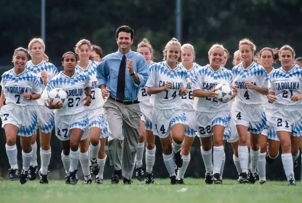 unc women's soccer team running with anson dorrance