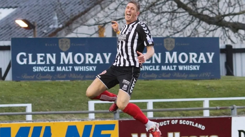 paul millar celebrating a goal for elgin city with a big jump in the air