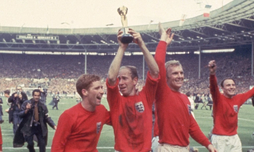 sir bobby charlton hold the world cup trophy above his head