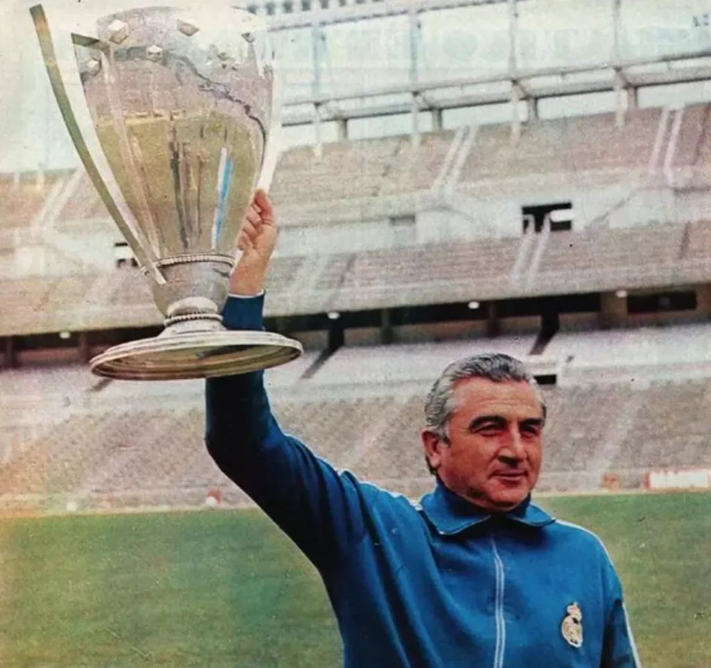 miguel munoz lifting the european cup above his head with one arm