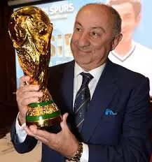an older osvaldo ardilies holding the world cup trophy