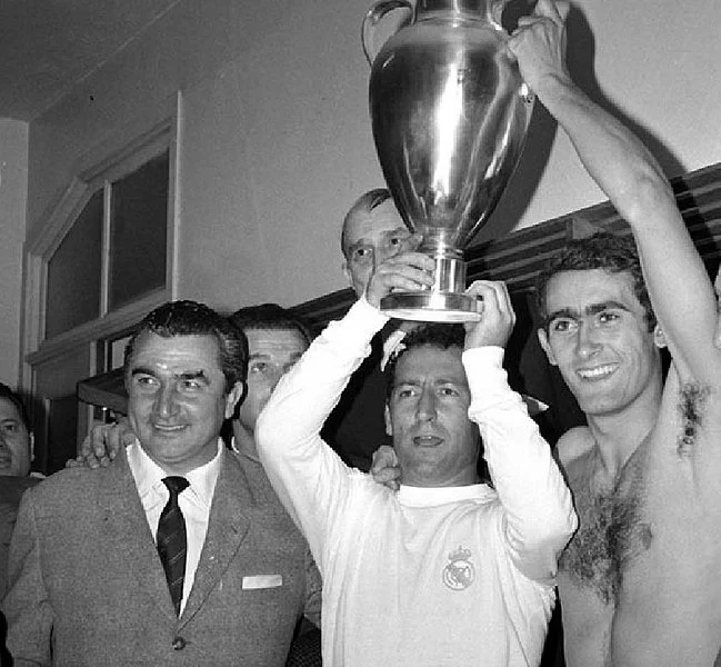 real madrid team lifting the european cup back in the changing rooms