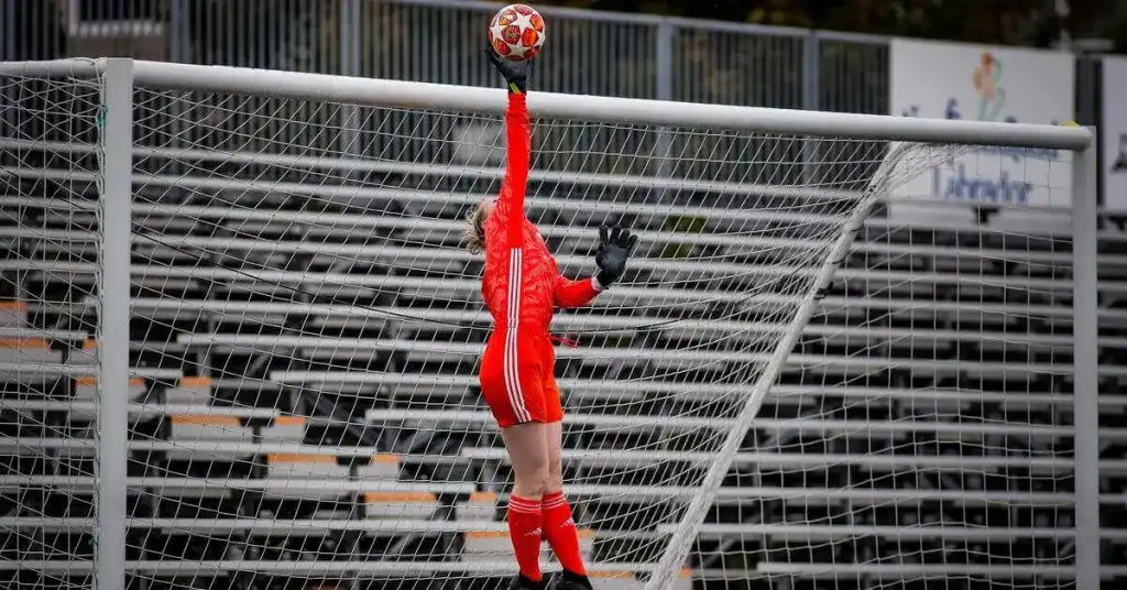 goalkeeper tipping the ball over the crossbar