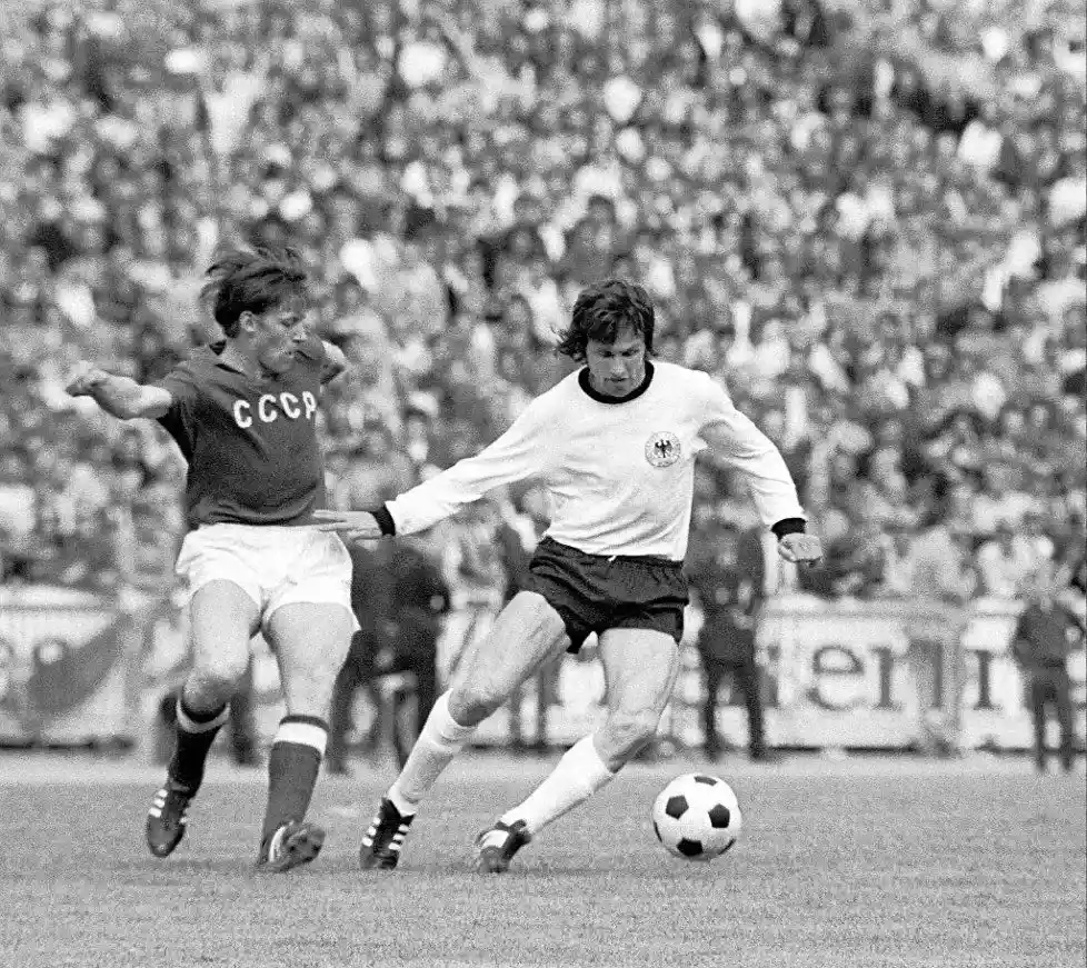 west germany player protecting ball from soviet union footballer