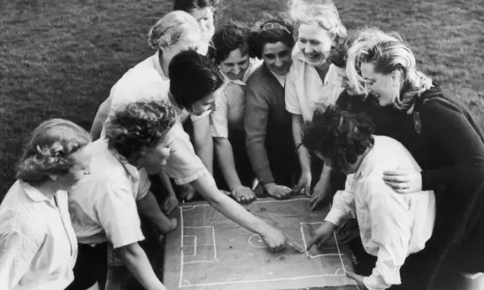 Dick Kerr Ladies womens football team discussing tactics