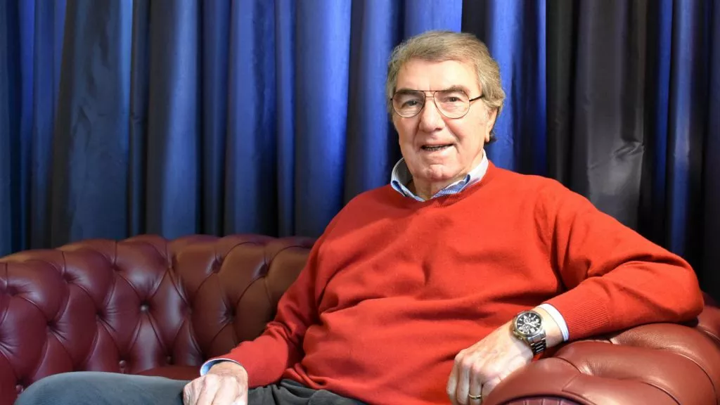 an older dino zoff sitting in a couch