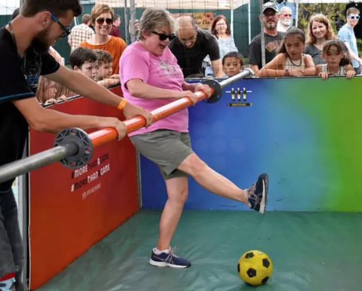 older lady playing human foosball