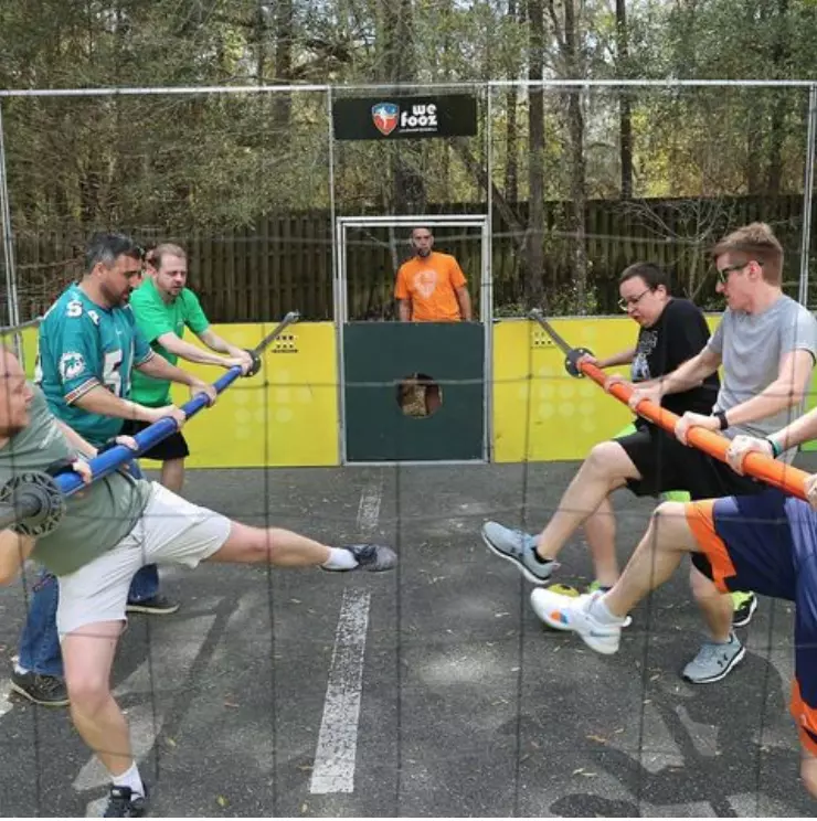 mates playing human foosball