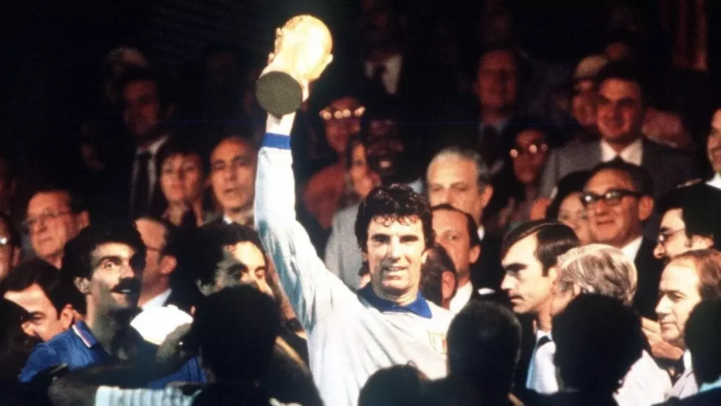 italian goalkeeper dino zoff holding up the world cup trophy
