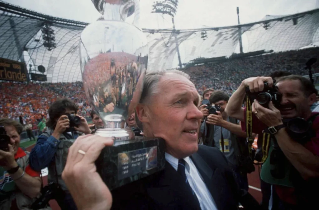 holding the euro 88 trophy on his shoulder