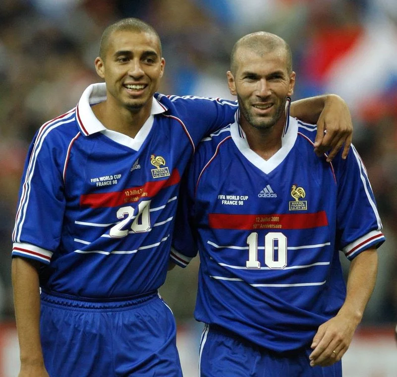 David Trezeguet and Zinedine Zidane walking off the pitch arm in arm