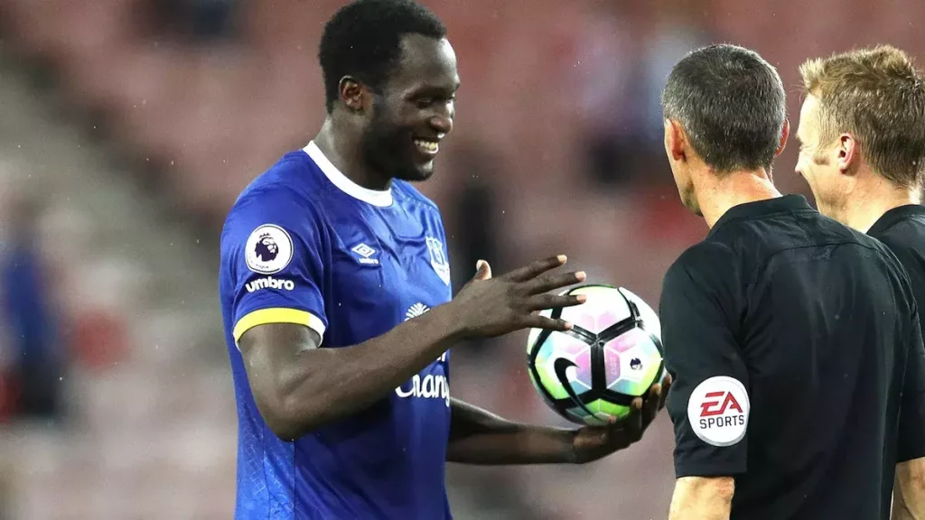 Lakaku receiving the match ball after scoring a hat trick from the referee