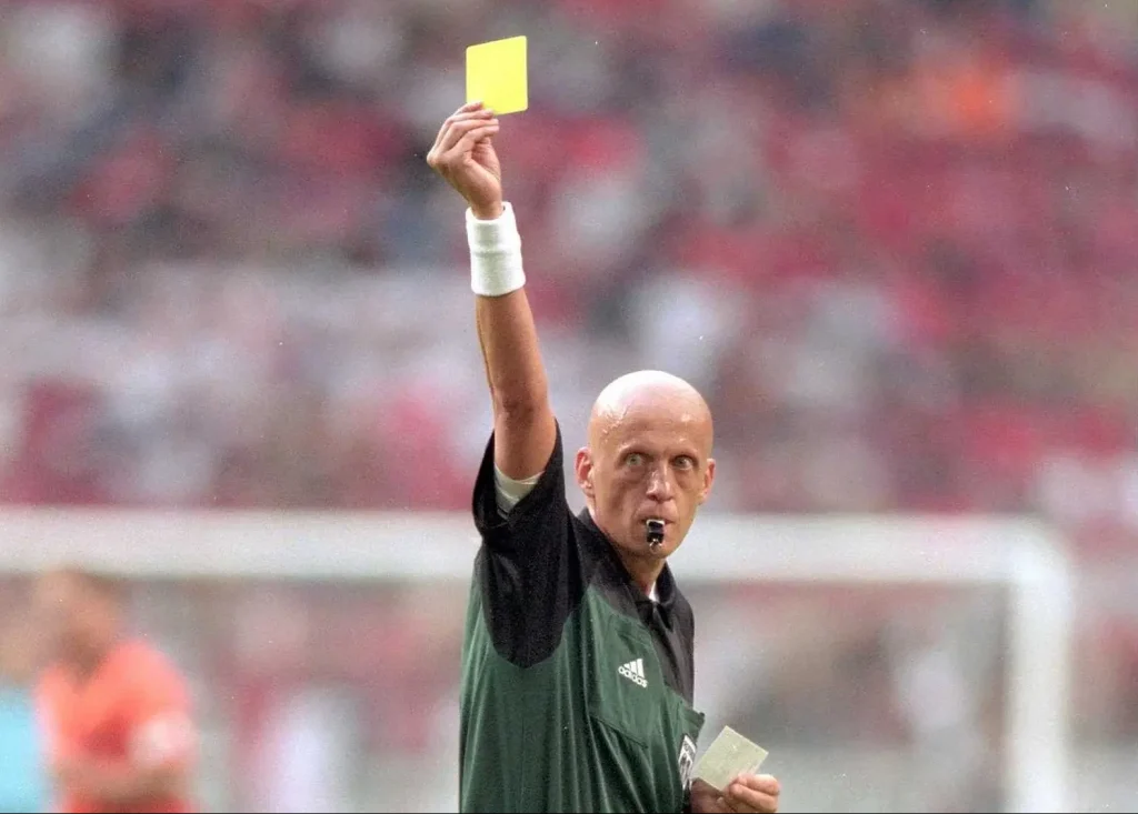 referee giving a yellow card to a soccer player Optimised