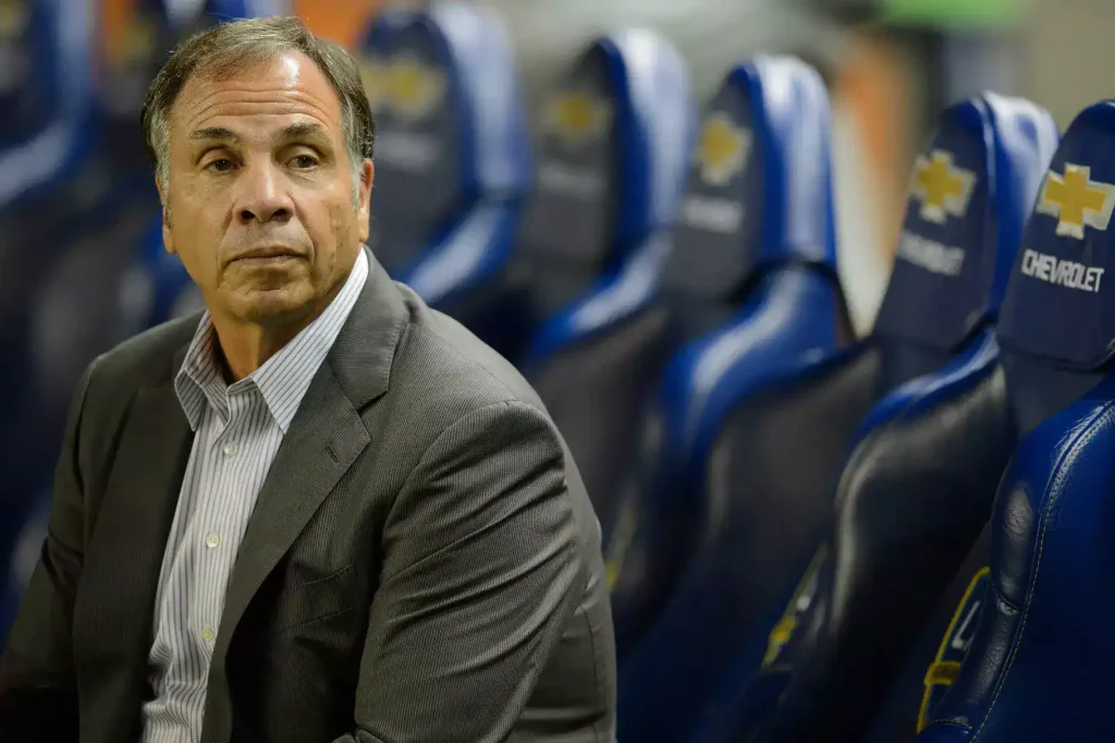 bruce arena sitting on the bench