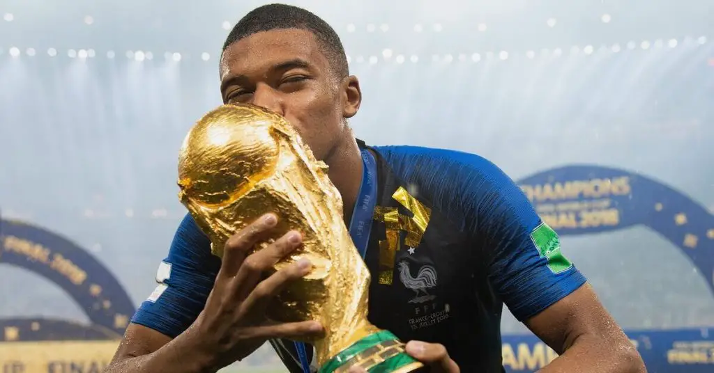 Kylian Mbappe kissing the world cup trophy 2018