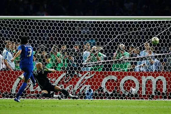 Fabio Grosso of Italy scores the winning penalty