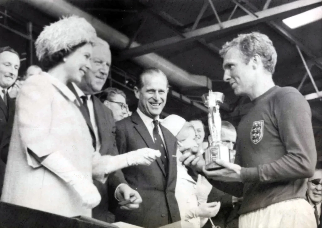 bobby moore receives the 1966 jules rimet trophy from the queen