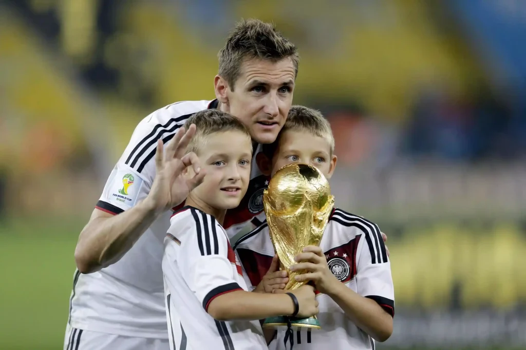 german soccer player klose with world cup trophy and his sons