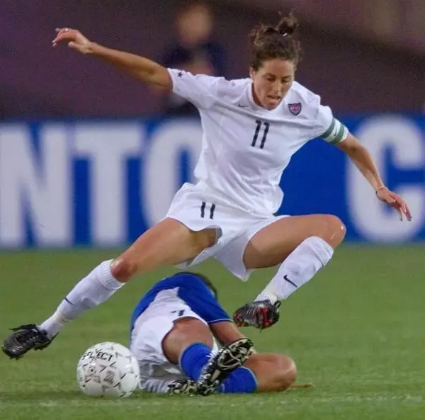 julie-foudy-jumping-a-soccer-tackle