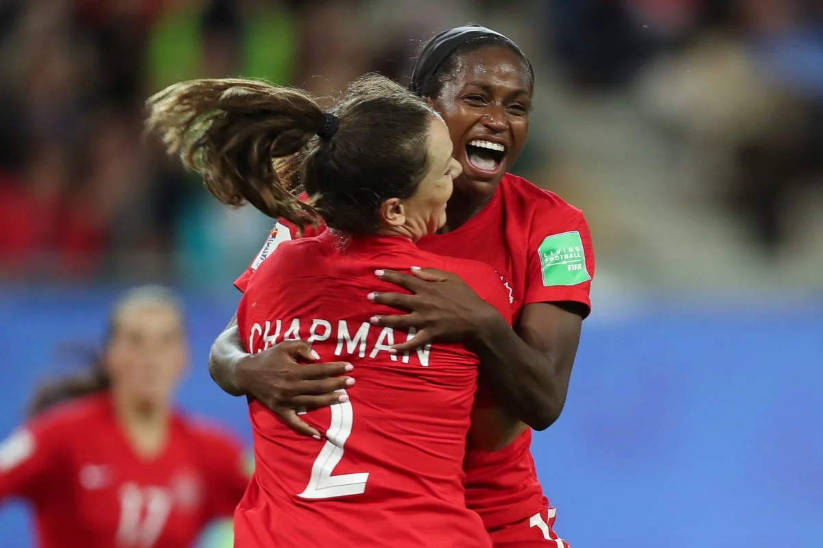 canada women soccer players hug and congratulate each other